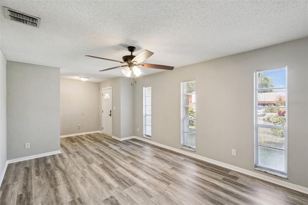 An empty room with light gray walls, beige tile flooring, and a ceiling fan — 4035 WENDY DRIVE, ORLANDO, FL