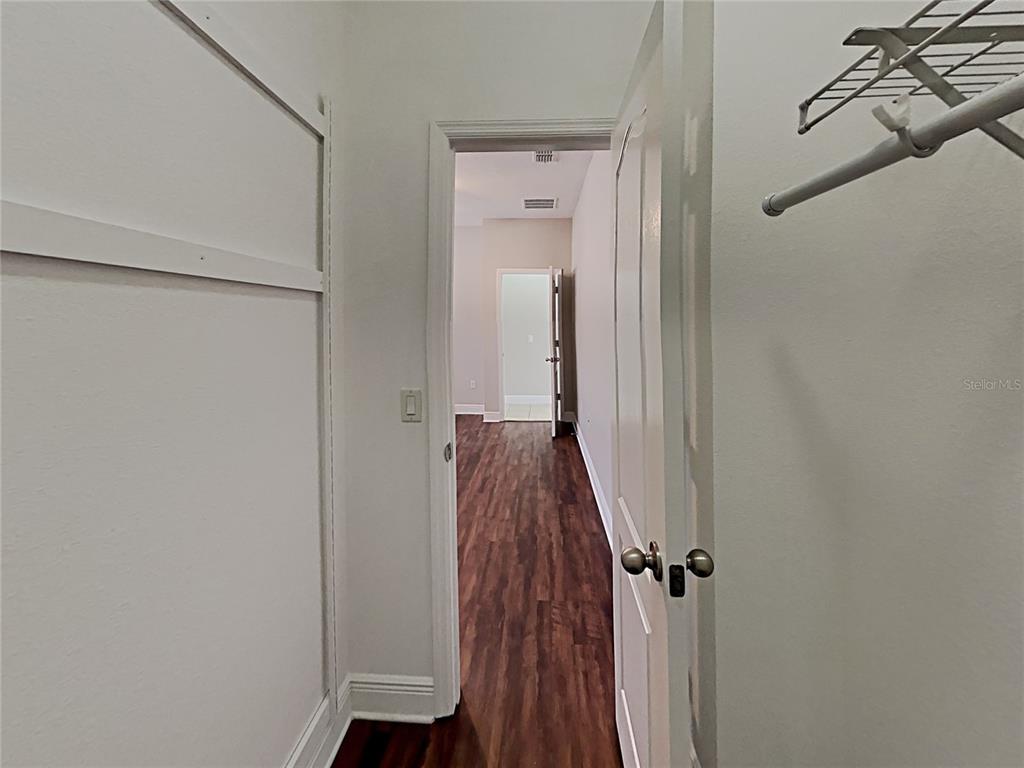 A view from inside a closet looking through a doorway into a hallway — 7033 FEATHER WOOD DR, RUSKIN, FL