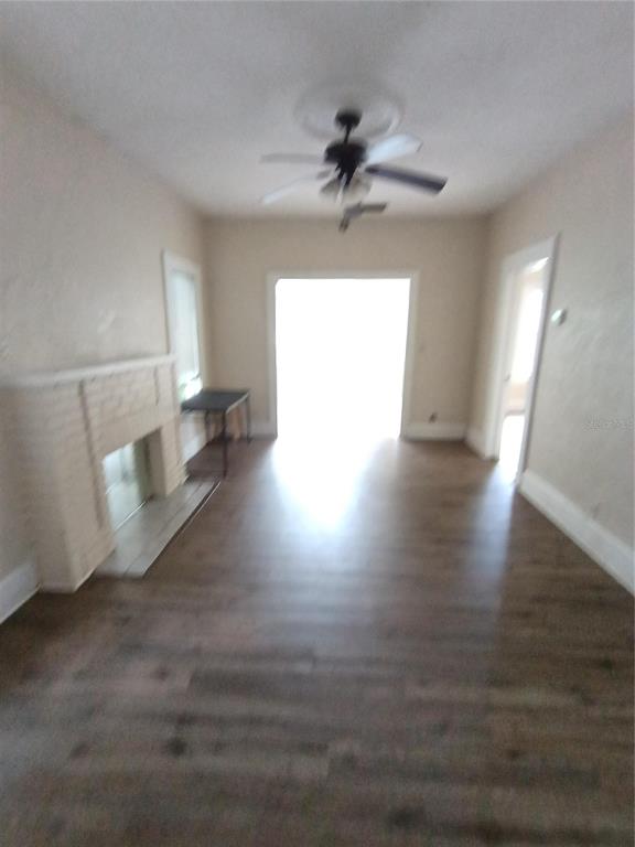 An empty bedroom features wood-look flooring, a ceiling fan, and a detached door leaning against wall — 1924 30TH STREET S, ST PETERSBURG, FL