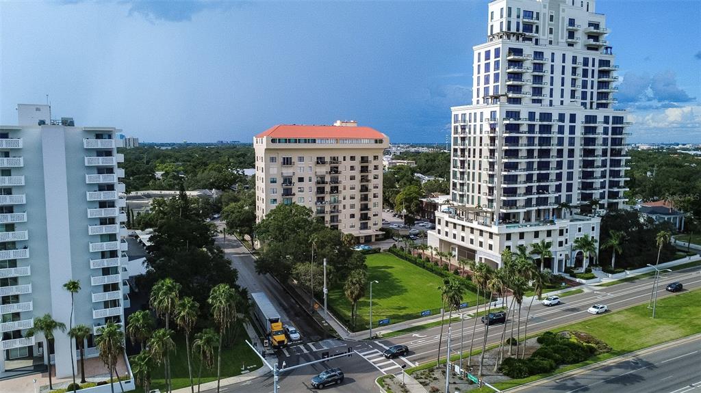 An aerial view shows three high-rise buildings and a green lawn near a city street — 2109 BAYSHORE BOULEVARD UNIT 303, TAMPA, FL