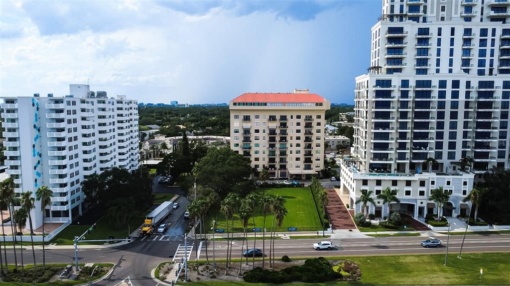 An aerial view shows three large apartment buildings separated by a green lawn and roads — 2109 BAYSHORE BOULEVARD UNIT 303, TAMPA, FL