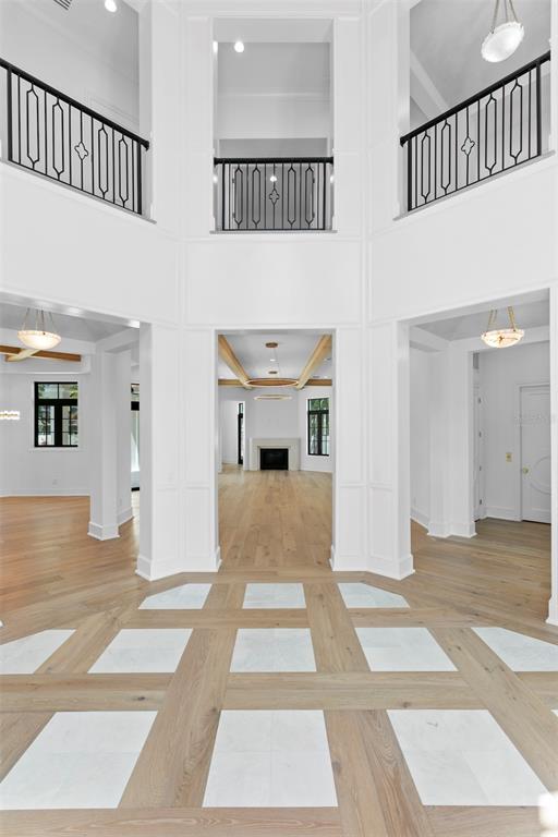 A grand foyer features a white-paneled two-story entryway with a patterned wood and marble floor — 3907 BAYSHORE BOULEVARD, TAMPA, FL