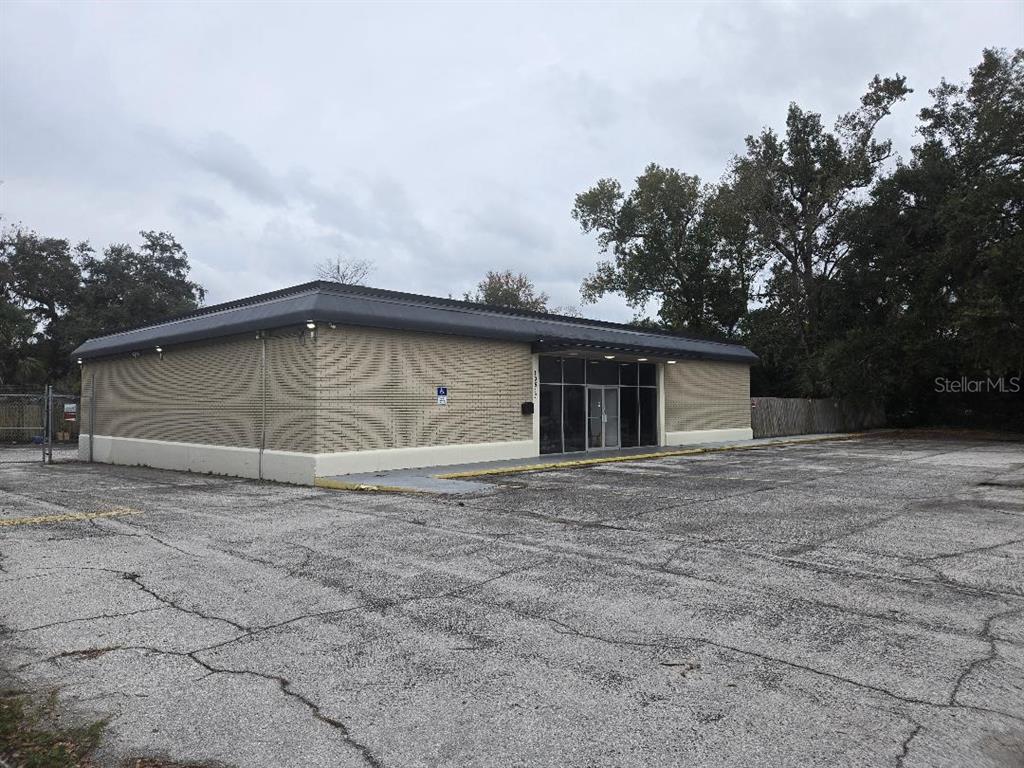 A single-story commercial building with a brick facade and a large asphalt parking lot — 10517 RIVERVIEW DRIVE, RIVERVIEW, FL