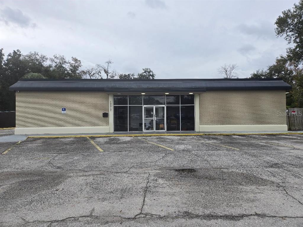 A single-story commercial building with a brick facade and a large glass storefront entrance — 10517 RIVERVIEW DRIVE, RIVERVIEW, FL