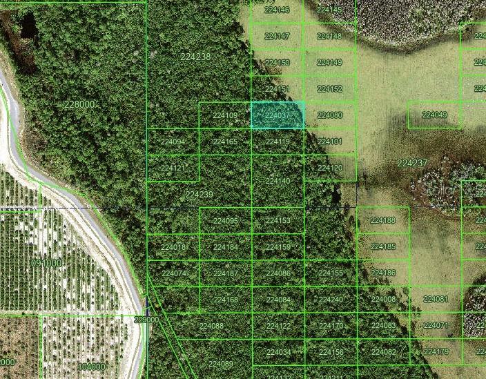 This is an aerial map showing a highlighted land parcel outlined in blue — TBD, POLK CITY, FL