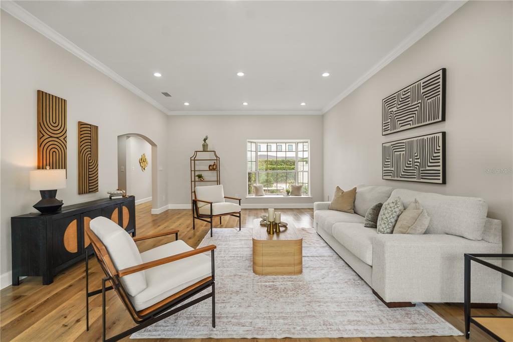 An empty room with light wood flooring, recessed lighting, and a sliding glass door — 2186 COUNTRYSIDE CIRCLE N, ORLANDO, FL