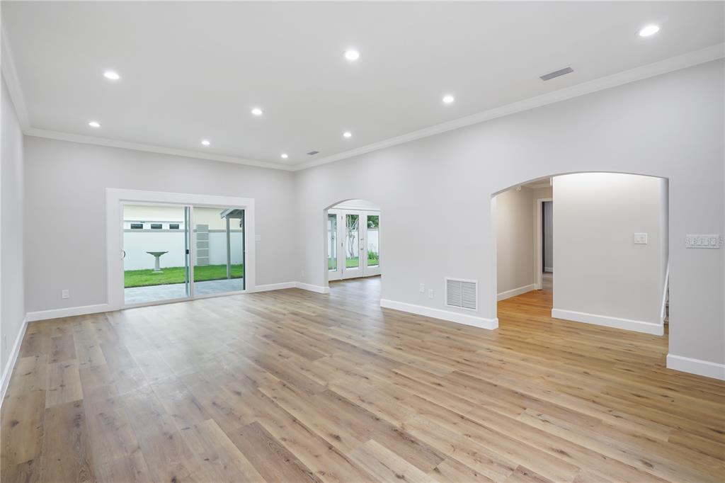 An empty room with light wood flooring, recessed lighting, and a sliding glass door — 2186 COUNTRYSIDE CIRCLE N, ORLANDO, FL