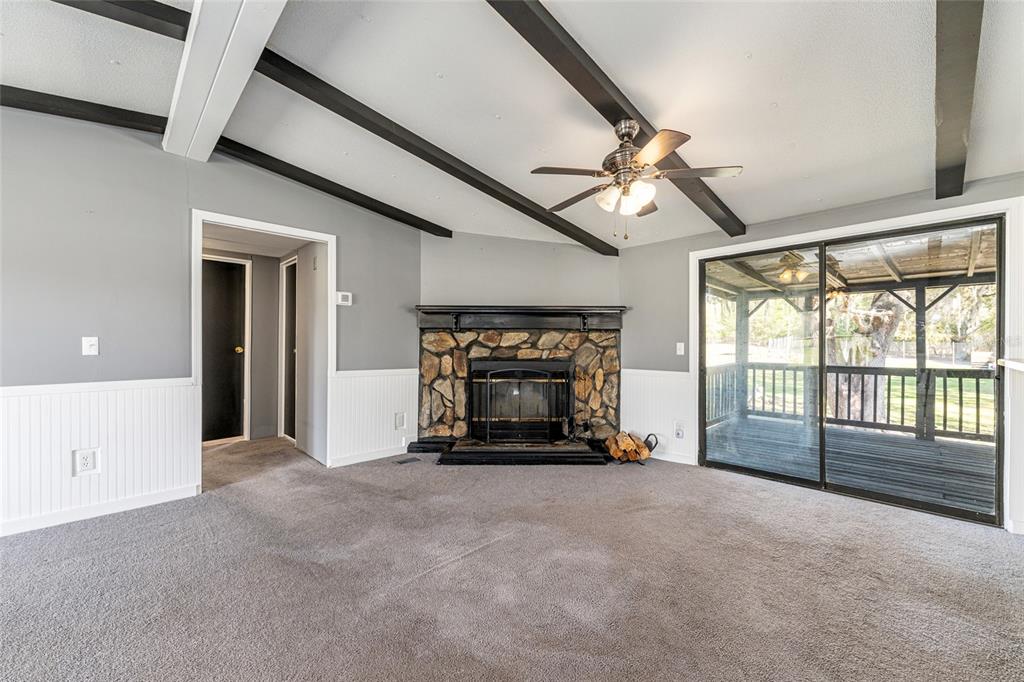 A kitchen with white cabinets, granite countertops, stainless steel appliances, and wood-look flooring — 5600 SE 39TH STREET, TRENTON, FL