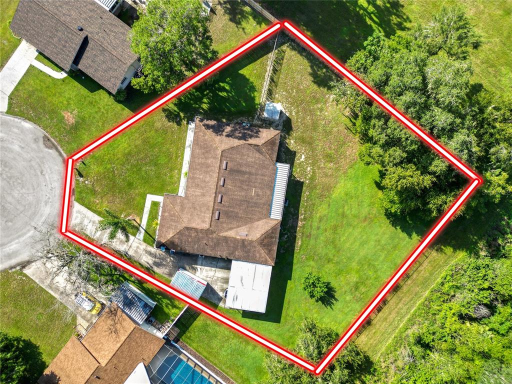 An aerial view shows a residential property with a house, yard, and surrounding trees — 1127 PINECREST DRIVE, BARTOW, FL