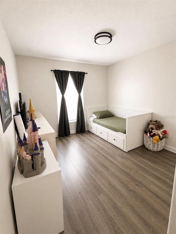 A bedroom features wood-look flooring, a white daybed with storage drawers, and a window with curtains — 631 OLD BRIDGE CIRCLE, DAVENPORT, FL