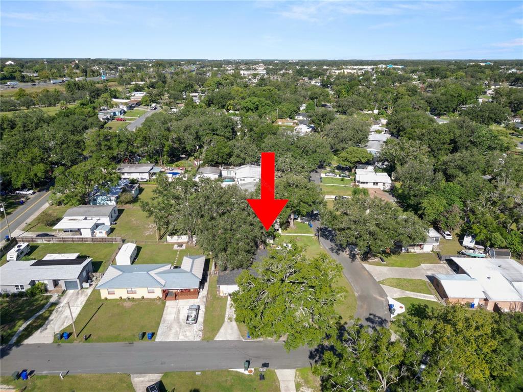 An aerial view shows a residential property with a red arrow pointing toward a house — 621 HILLSIDE DRIVE, LAKELAND, FL