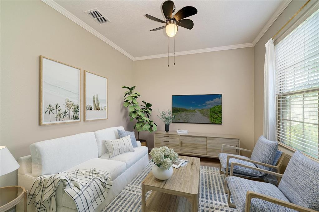 A living room features a white sofa, two blue armchairs, a coffee table, and television — 6031 100TH AVENUE E, PARRISH, FL