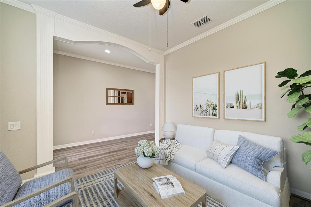 A living room features a white sofa, wood coffee table, and an arched entryway — 6031 100TH AVENUE E, PARRISH, FL