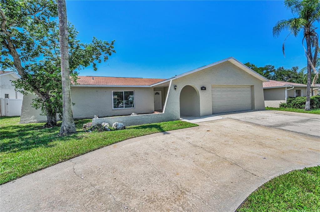 An outdoor swimming pool with a screen enclosure, patio, and a wooden privacy fence — 11121 PEPPERTREE LANE, PORT RICHEY, FL