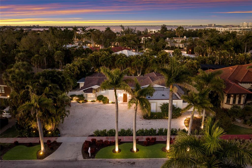 An aerial view shows a single-story house with a gravel driveway and palm trees — 103 FILLMORE DRIVE, SARASOTA, FL