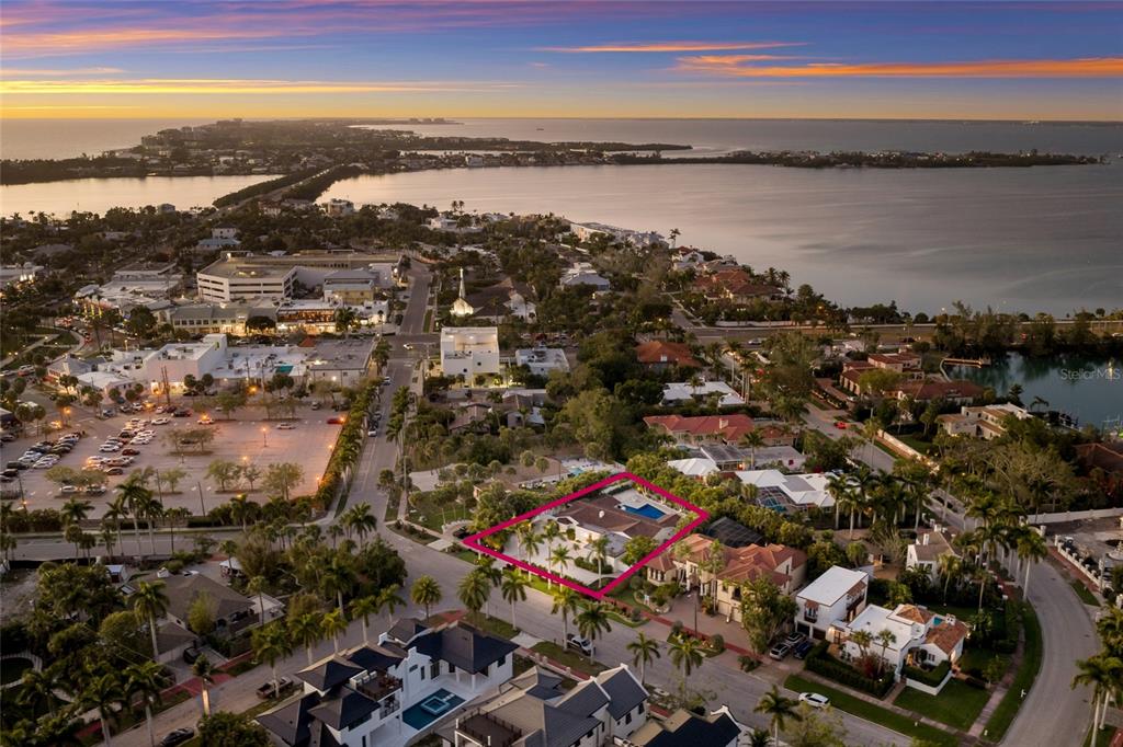 An aerial view shows a residential property outlined in pink near a coastal town — 103 FILLMORE DRIVE, SARASOTA, FL