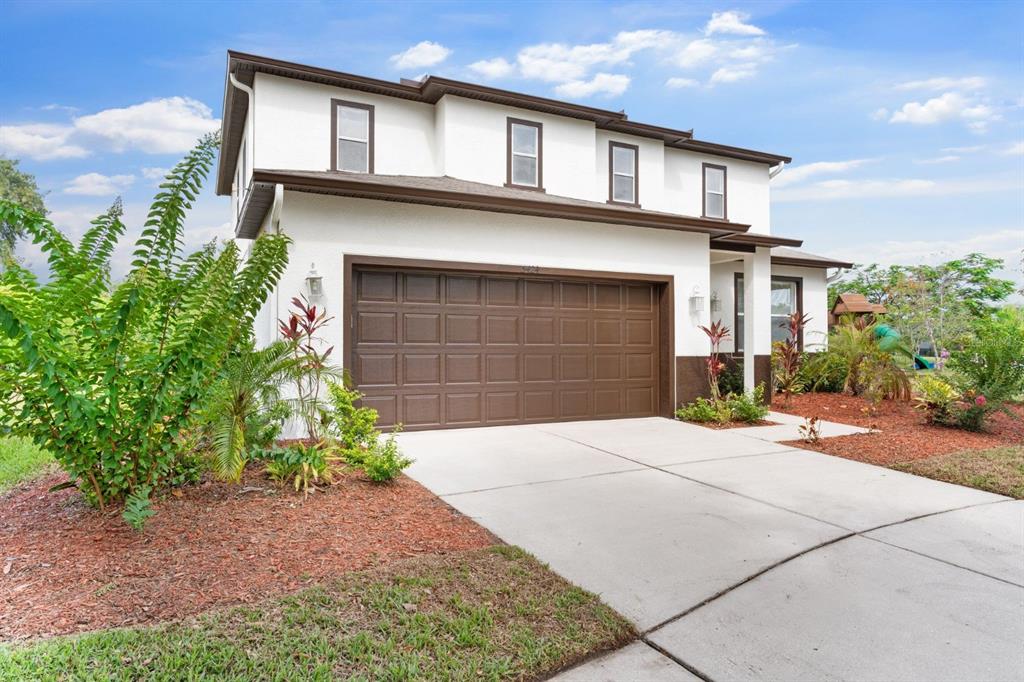 A two-story house with a white stucco exterior, brown trim, and a two-car garage — 5424 HAMMOCK VIEW LANE, APOLLO BEACH, FL