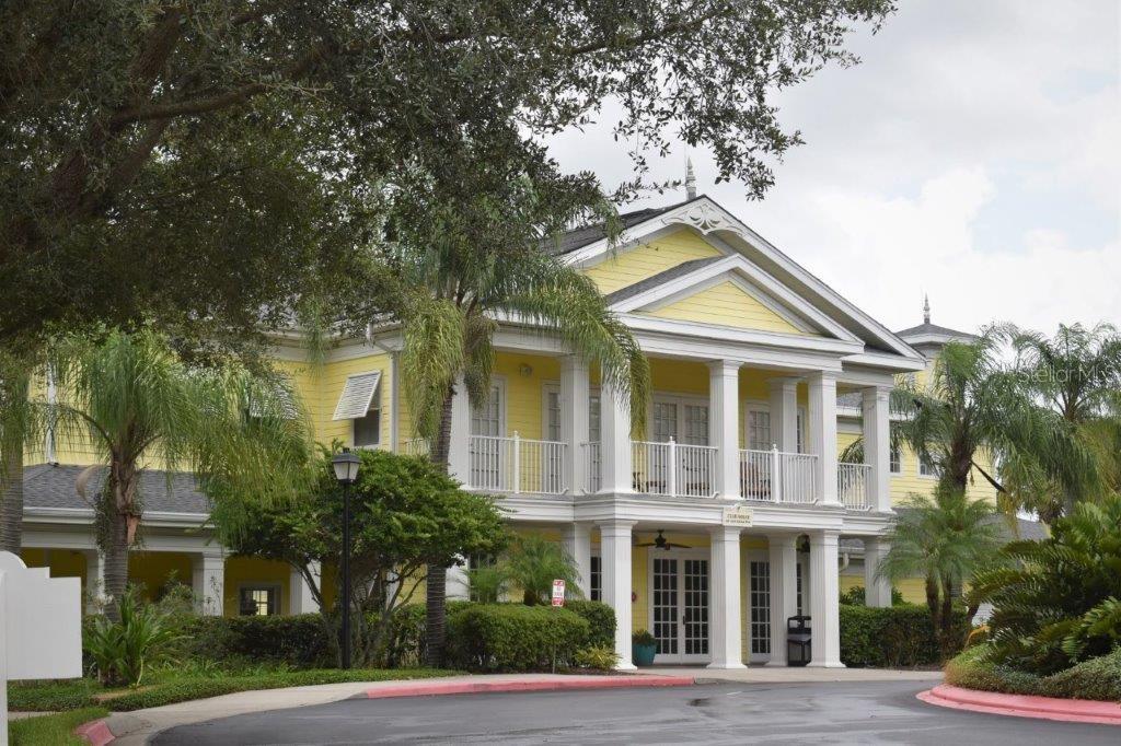 A two-story yellow building with a white columned porch and a triangular roof gable — 603 NEW PROVIDENCE UNIT 603, DAVENPORT, FL