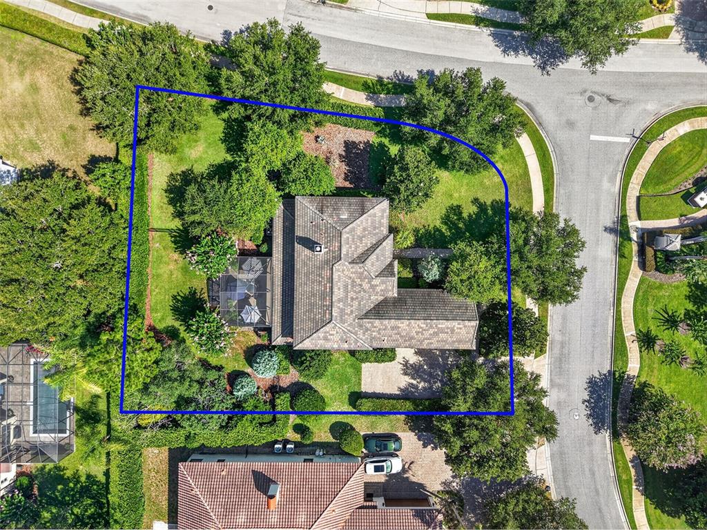 A two-story house with a stone facade and a brick walkway leading to the entrance — 3000 ISOLA BELLA BOULEVARD, MOUNT DORA, FL