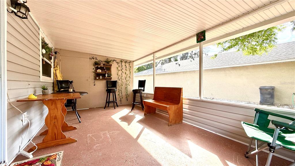 A kitchen features white cabinets, granite countertops, stainless steel appliances, and wood-look flooring — 111 NE PALENCIA ROAD, AUBURNDALE, FL