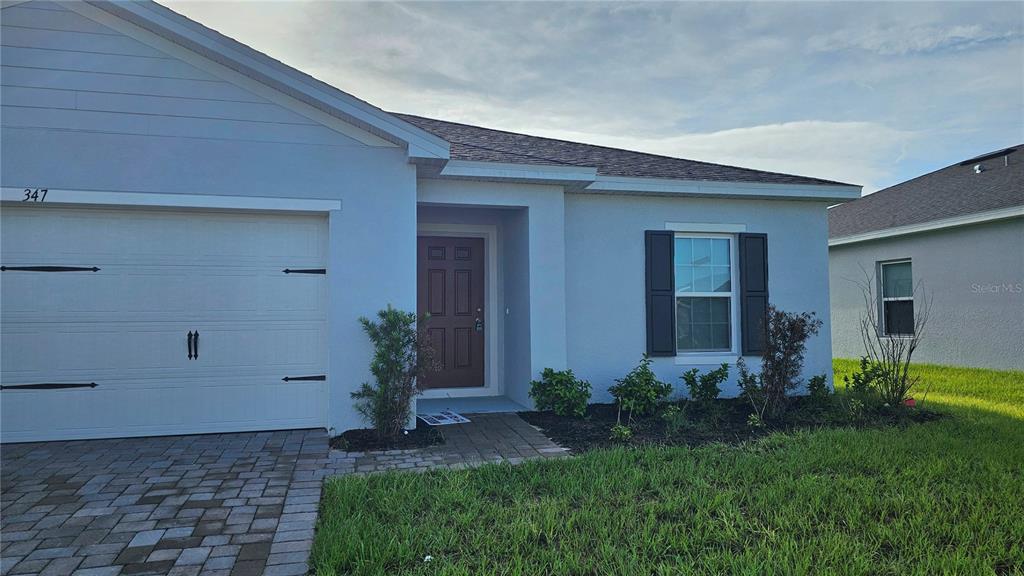 A kitchen with white cabinets, stainless steel appliances, and a granite-topped island — 347 BILTMORE BOULEVARD, DUNDEE, FL