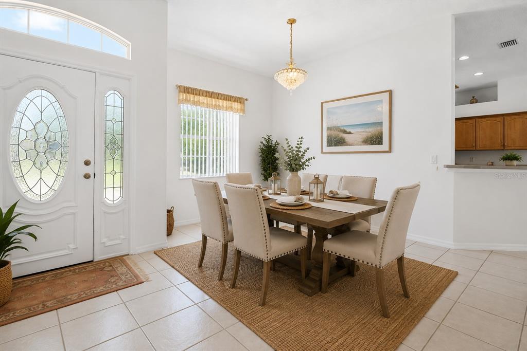 A kitchen with light wood cabinets, gray countertops, and tile flooring — 25 WESTMINSTER DRIVE, PALM COAST, FL