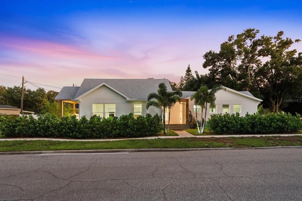 A white single-story house with a gray roof and palm trees at dusk — 4847 DR MARTIN LUTHER KING JR STREET N, ST PETERSBURG, FL