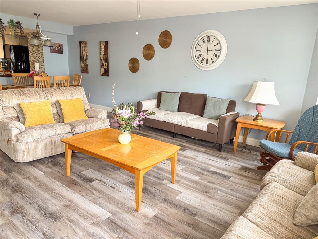 A kitchen features white cabinets, dark wood countertops, a black stove, and a tiled backsplash — 2731 N POINCIANA BOULEVARD UNIT 105, KISSIMMEE, FL