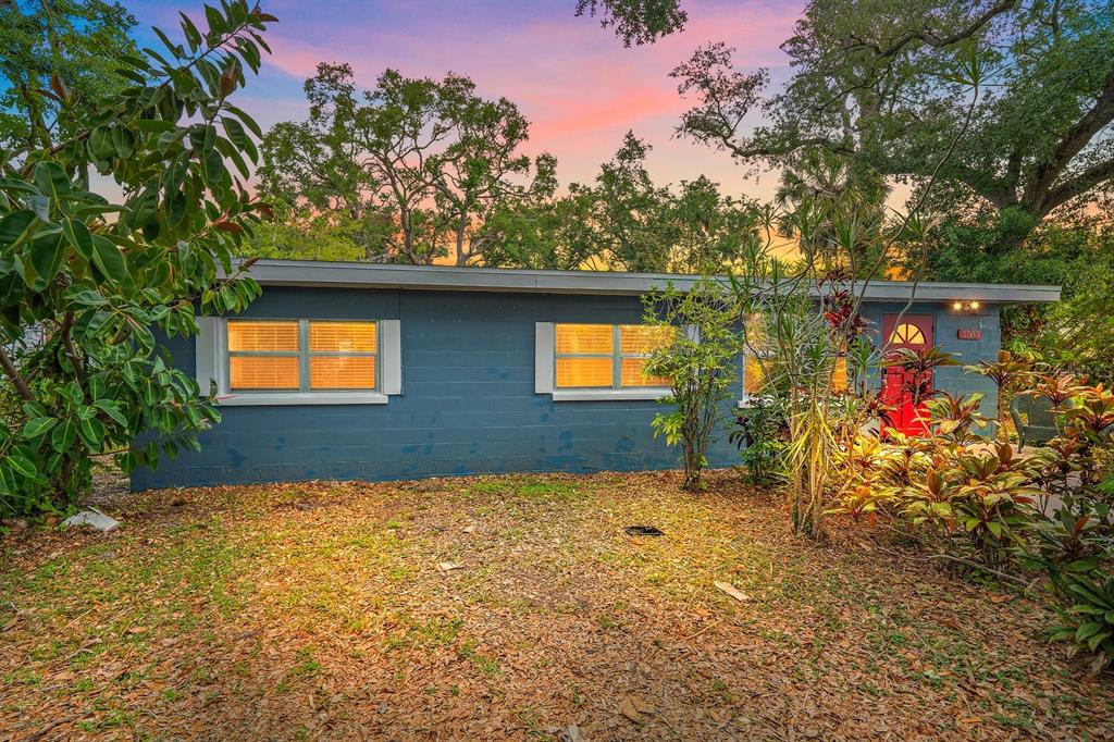 A living room with light blue walls, wood-look tile flooring, a ceiling fan, and furniture — 2503 53RD AVENUE W, BRADENTON, FL