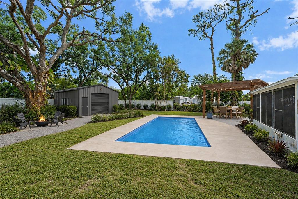 A kitchen with light blue walls, wood cabinets, stainless steel appliances, and wood-look tile flooring — 2503 53RD AVENUE W, BRADENTON, FL