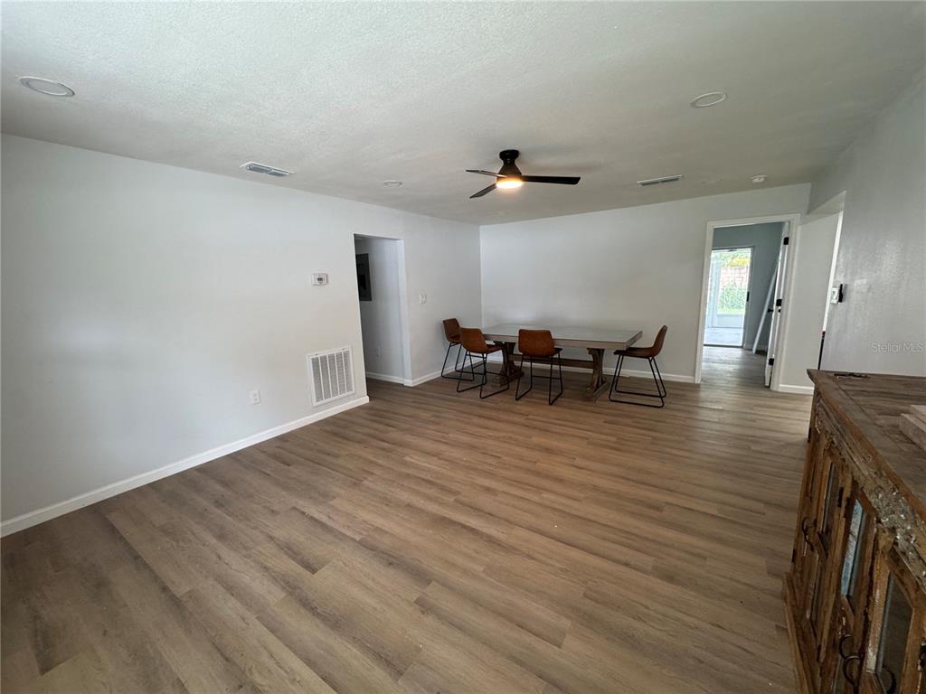 A kitchen features gray cabinets, white countertops, stainless steel appliances, and wood-look flooring — 1407 MOSELLE AVENUE, ORLANDO, FL