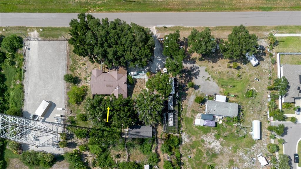 An aerial view shows a house with a brown roof surrounded by trees and structures — 11109 SUMNER ROAD, WIMAUMA, FL