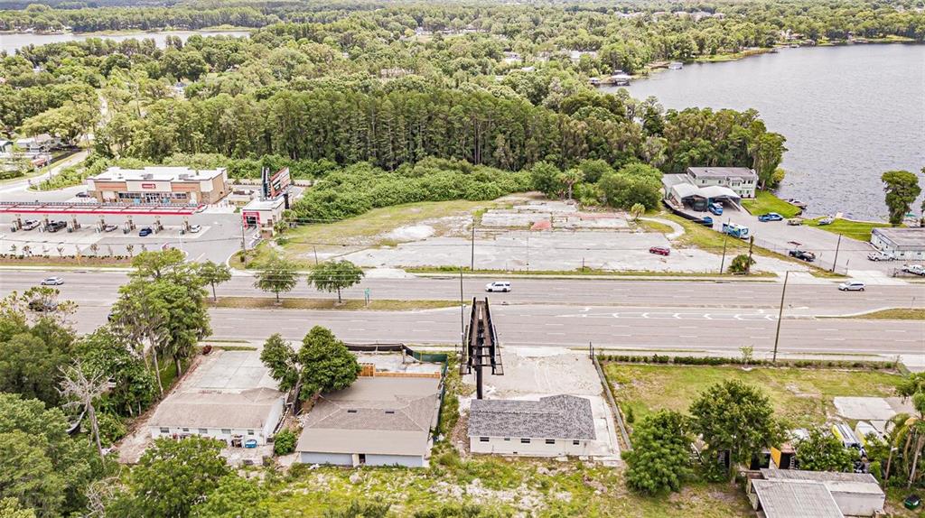 An aerial view shows a commercial property with a billboard and a vacant lot — 4623 LAND O LAKES BOULEVARD, LAND O LAKES, FL