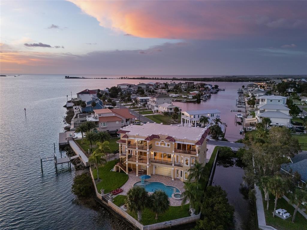 An aerial view of a multi-story waterfront home with a pool and a private dock — 3236 GULF WINDS CIRCLE, HERNANDO BEACH, FL