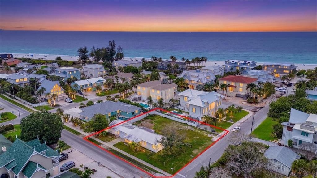 An aerial view shows a single-story house on a corner lot near the beach — 121 48TH STREET, HOLMES BEACH, FL
