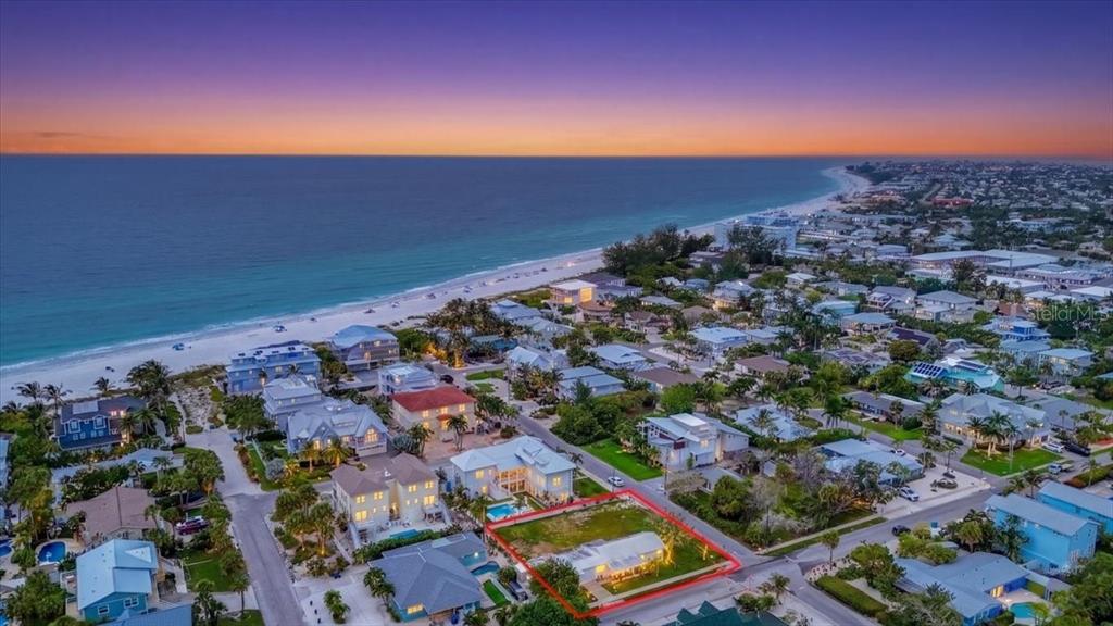 An aerial view shows a coastal neighborhood with a highlighted residential lot near the beach — 121 48TH STREET, HOLMES BEACH, FL
