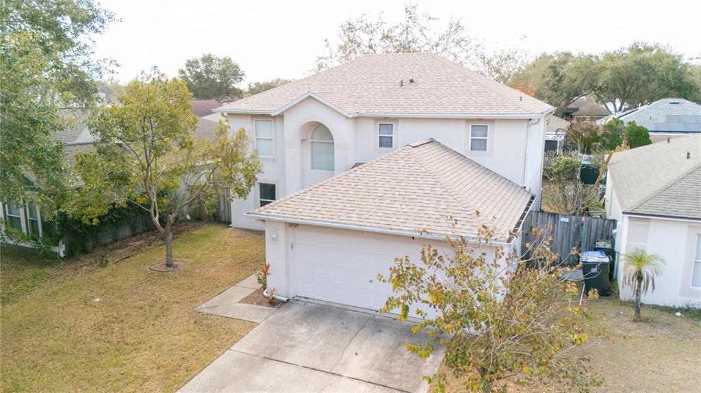 An aerial view of a two-story house with a beige exterior and a shingled roof — 10529 MARONDA DRIVE, RIVERVIEW, FL