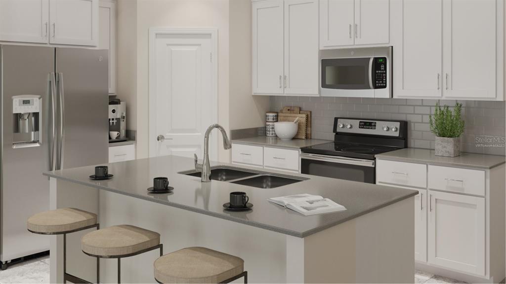 This is a rendering of a modern kitchen featuring white cabinets, stainless appliances, and an island — 5204 WORCHESTER DRIVE, KISSIMMEE, FL