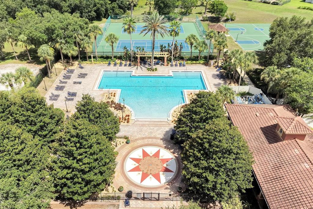 An aerial view shows a swimming pool, tennis courts, and a basketball court — 554 PALIO COURT, OCOEE, FL