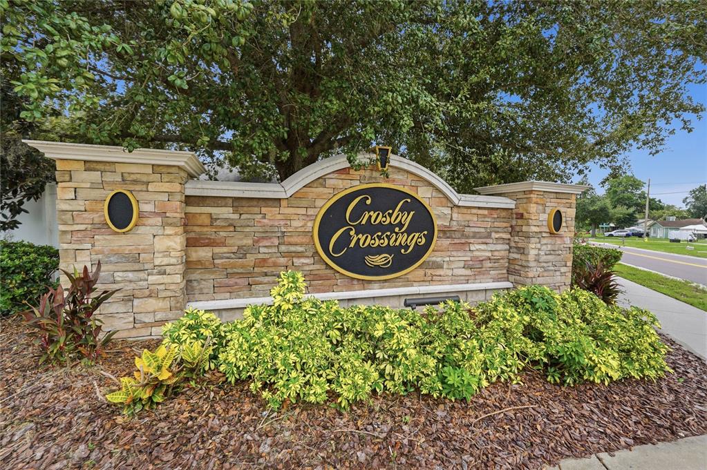 A stone monument sign for Crosby Crossings stands in front of a large tree — 311 WESTCHESTER HILLS LANE, VALRICO, FL