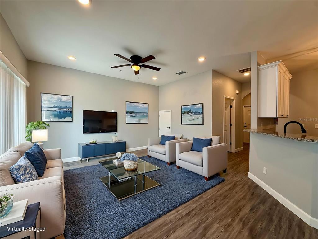 A multi-unit residential building with light blue siding, white trim, and attached garages — 2531 PINE PLACE, WINTER HAVEN, FL