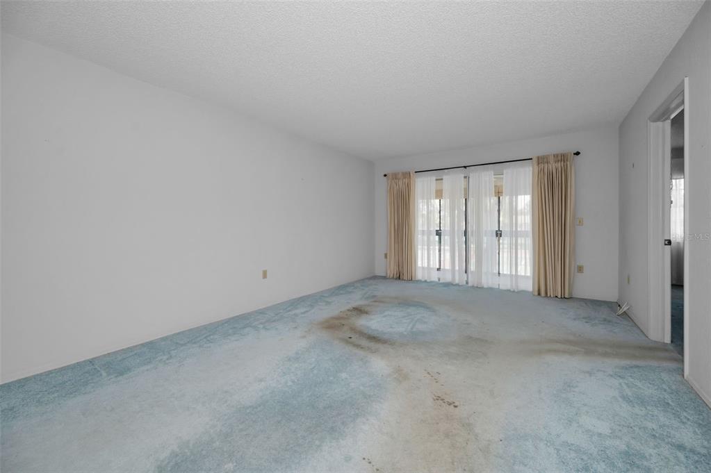 A two-story apartment building with a parking lot in the foreground — 9700 STARKEY ROAD UNIT 228, SEMINOLE, FL