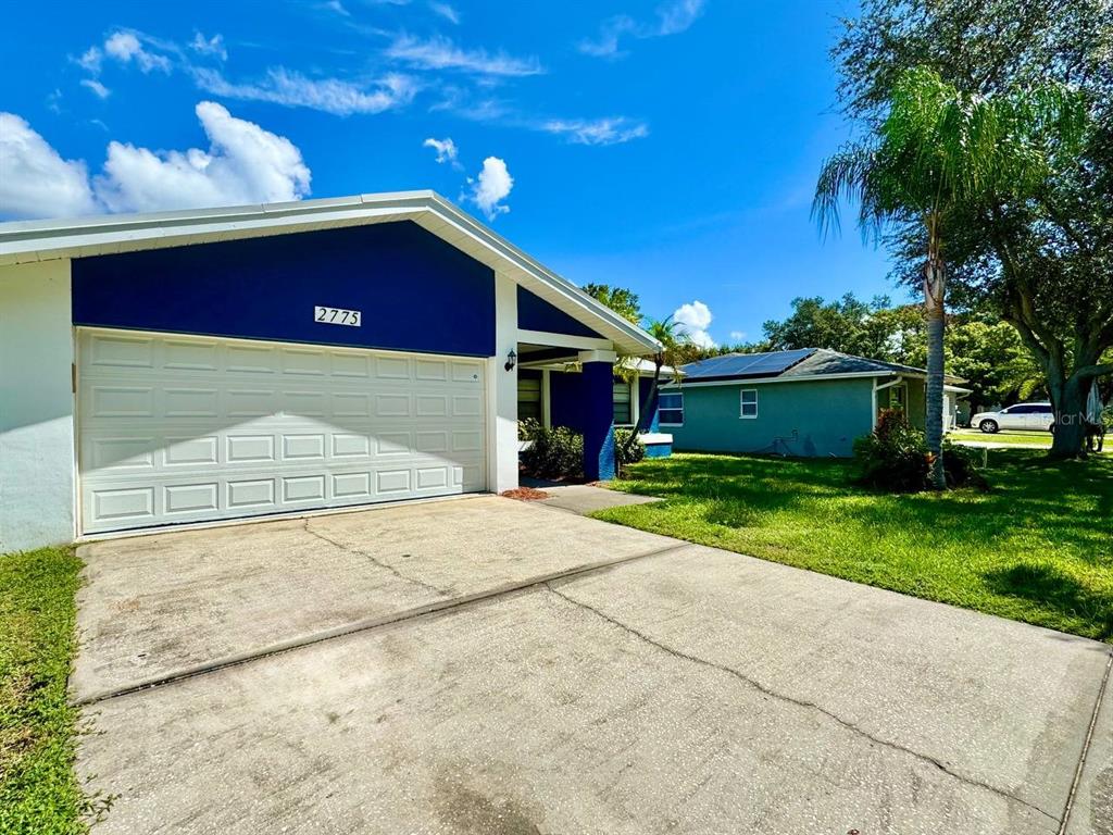 A blue and white house with a two-car garage and a concrete driveway — 2775 DIANE TERRACE, CLEARWATER, FL