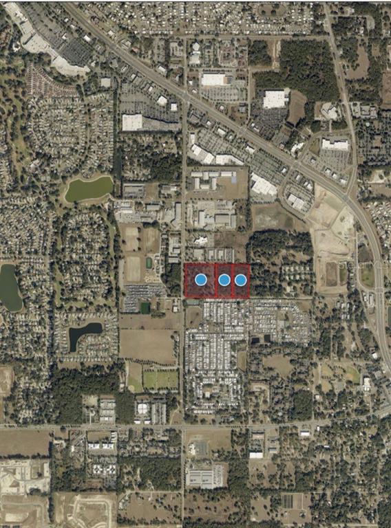An aerial map view shows three adjacent rectangular plots of land highlighted in red — 451 ROLLING ACRES ROAD, LADY LAKE, FL