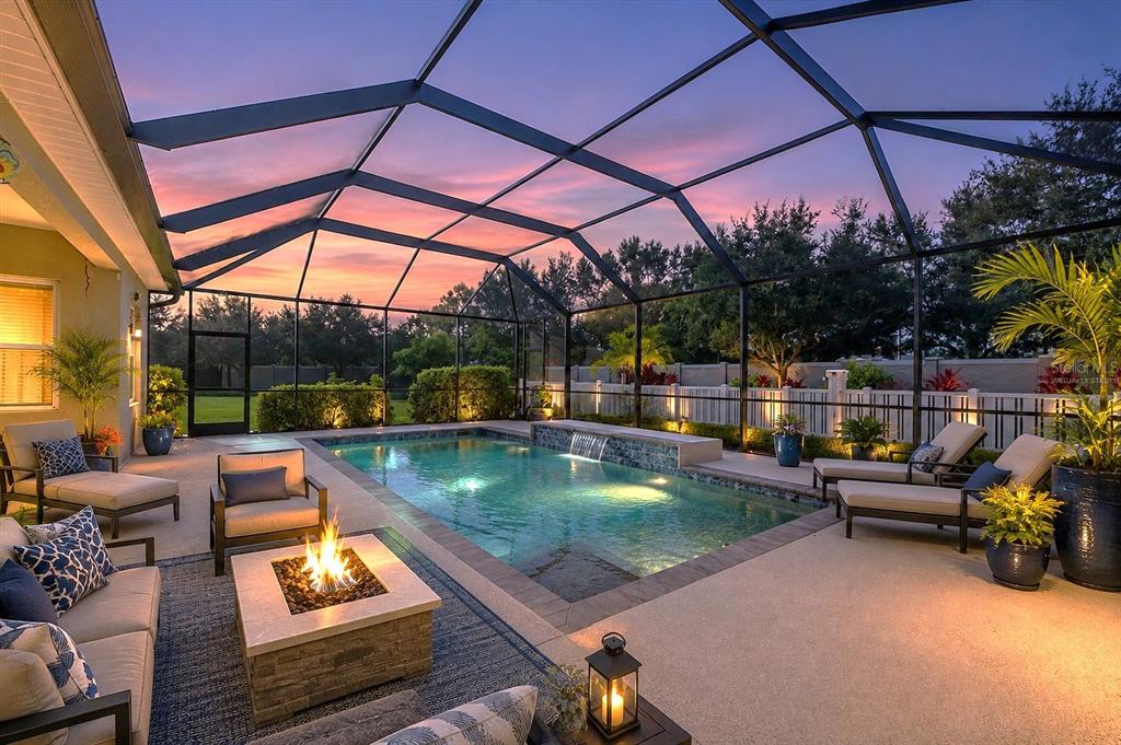 An aerial view shows a single-story house with a driveway and a neighboring two-story home — 7040 WHITE WILLOW COURT, SARASOTA, FL