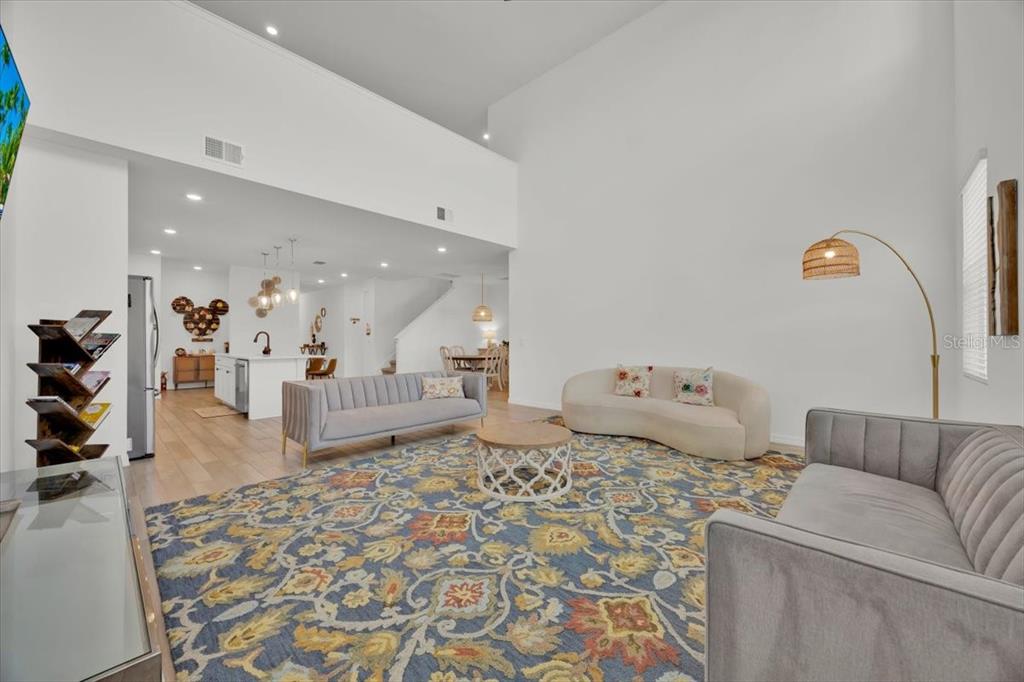 A two-story blue house with a two-car garage and a covered front porch — 2342 LANCASHIRE STREET, DAVENPORT, FL