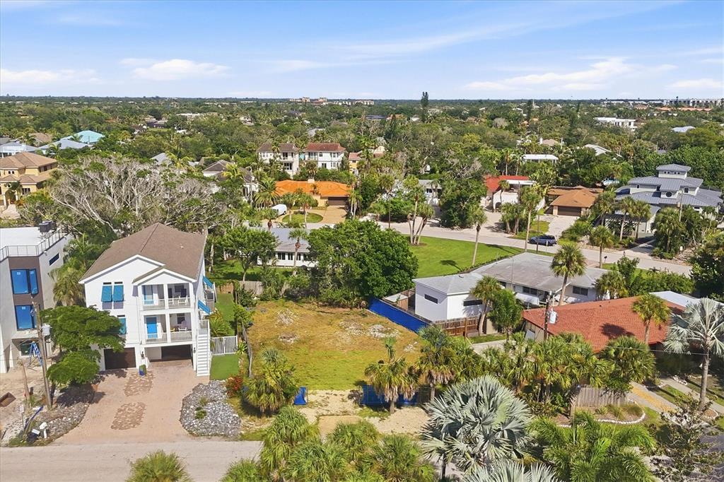An aerial view shows a vacant residential lot situated between two houses in a neighborhood — 5375 CALLE FLORIDA, SARASOTA, FL