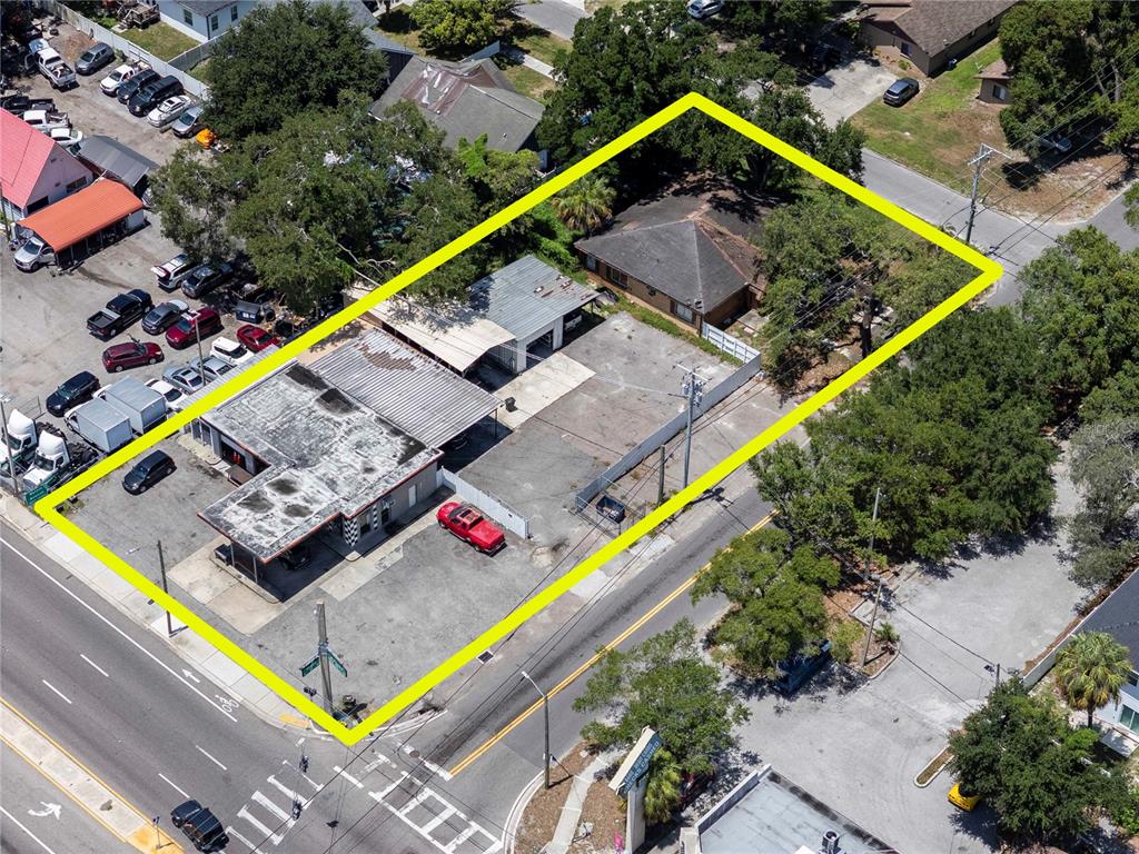 An aerial view shows a commercial property with a paved lot and two buildings — 8624 N FLORIDA AVENUE, TAMPA, FL