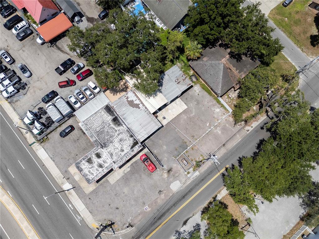 An aerial view shows a commercial building with a parking lot and surrounding trees — 8624 N FLORIDA AVENUE, TAMPA, FL