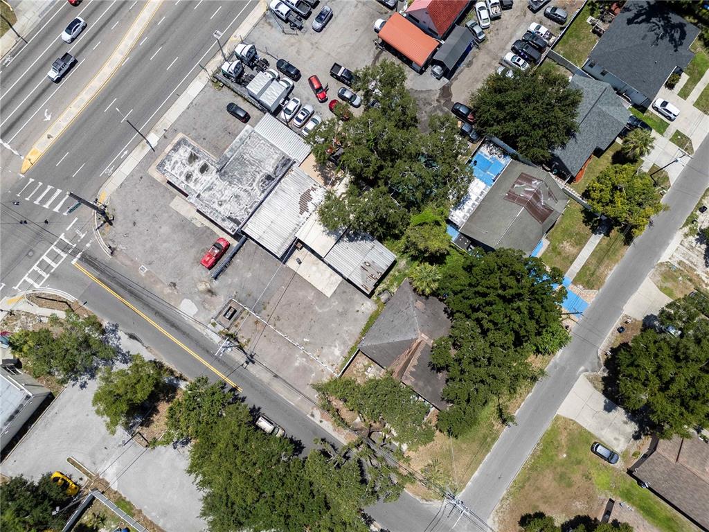 Aerial view of a commercial property with a parking lot and adjacent residential buildings — 8624 N FLORIDA AVENUE, TAMPA, FL